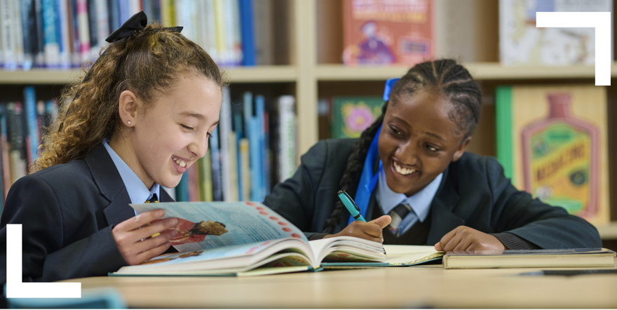 students browsing a book in the school library