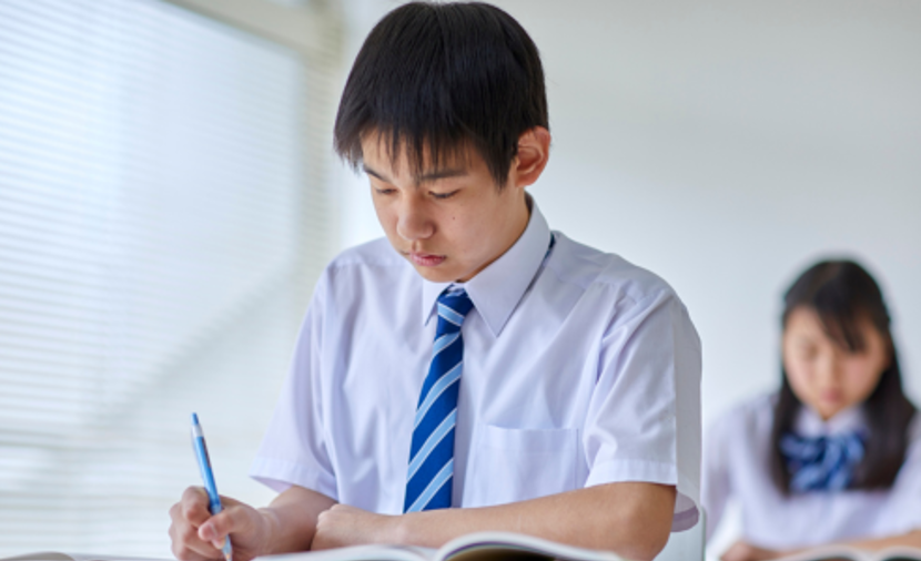student taking notes in class